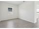 Neutral bedroom with light-filled window and light wood look flooring at 1878 Draughton Dr, Zephyrhills, FL 33541