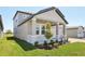 Front exterior with a covered porch, showcasing stone accents and manicured landscaping at 1878 Draughton Dr, Zephyrhills, FL 33541