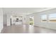 Open-concept living room flows into the kitchen with sliding door access to the backyard and a serene pond view at 1878 Draughton Dr, Zephyrhills, FL 33541