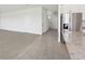 Open-concept living space with sleek tile flooring, stainless steel appliances, and bright natural light at 1878 Draughton Dr, Zephyrhills, FL 33541