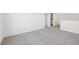 Bright loft space features neutral carpet, with an adjacent laundry room at 1878 Draughton Dr, Zephyrhills, FL 33541