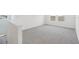 Loft space featuring neutral carpet, white walls, and a large window offering plenty of natural light at 1878 Draughton Dr, Zephyrhills, FL 33541