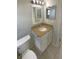 Bathroom features a granite counter, white cabinets, and a toilet at 3213 Bigelow Dr, Holiday, FL 34691