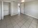 Bright bedroom features tile floors, a ceiling fan, and a closet at 3213 Bigelow Dr, Holiday, FL 34691
