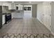 Kitchen features white cabinets, stainless steel appliances, and tile floors at 3213 Bigelow Dr, Holiday, FL 34691