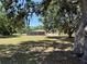 Expansive backyard with mature trees, offering ample space and potential for outdoor activities at 3652 Oak Grove Dr, Sarasota, FL 34243
