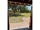 A view to the lush backyard and patio, with trees providing a serene and private outdoor space at 3652 Oak Grove Dr, Sarasota, FL 34243
