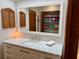 Bright bathroom with a large mirror, white marble vanity, and wood louvered cabinet at 3652 Oak Grove Dr, Sarasota, FL 34243