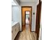 Bathroom hallway with tile flooring, white cabinet, and access to outdoor patio at 3652 Oak Grove Dr, Sarasota, FL 34243