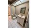 A clean bathroom featuring a white vanity and toilet with tiled flooring at 3652 Oak Grove Dr, Sarasota, FL 34243