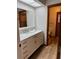 Bathroom showing vanity with marble countertop, and tile flooring and access to the toilet at 3652 Oak Grove Dr, Sarasota, FL 34243