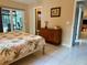 Bedroom features tiled floors and a view of the patio and lanai at 3652 Oak Grove Dr, Sarasota, FL 34243