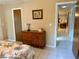 Bedroom with tile floors, wooden dresser, and doorway leading to another room at 3652 Oak Grove Dr, Sarasota, FL 34243