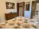 Comfortable bedroom featuring floral bedding, dresser, and a mirror adding depth to the space at 3652 Oak Grove Dr, Sarasota, FL 34243