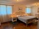 Bright bedroom featuring a woven headboard, neutral walls, and warm lighting at 3652 Oak Grove Dr, Sarasota, FL 34243
