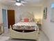 Cozy bedroom boasts white accents, tiled floors and a queen-sized bed at 3652 Oak Grove Dr, Sarasota, FL 34243