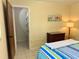 Cozy bedroom with tiled floors, a lamp, and a view of the closet at 3652 Oak Grove Dr, Sarasota, FL 34243