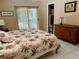 Bedroom featuring tropical bedding, tile floors, and a sliding door to the outside at 3652 Oak Grove Dr, Sarasota, FL 34243