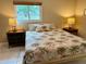 Inviting bedroom with tropical bedding, and bedside tables, creating a serene atmosphere at 3652 Oak Grove Dr, Sarasota, FL 34243
