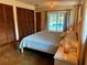 Well-lit bedroom with a view to the pool, comfortable bed, and stylish decor at 3652 Oak Grove Dr, Sarasota, FL 34243