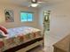 Bedroom features tiled floors, a ceiling fan and a view of the en suite bath at 3652 Oak Grove Dr, Sarasota, FL 34243