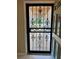 Unique decorative front door with security screen, adding charm and protection to the entryway at 3652 Oak Grove Dr, Sarasota, FL 34243