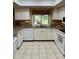 Well-lit kitchen featuring white cabinetry, granite countertops, and modern appliances at 3652 Oak Grove Dr, Sarasota, FL 34243