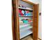 Spacious linen closet with wood trim and shelves lined with decorative paper, filled with colorful towels at 3652 Oak Grove Dr, Sarasota, FL 34243
