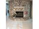 Elegant stone fireplace adding a touch of rustic charm to the inviting living space at 3652 Oak Grove Dr, Sarasota, FL 34243