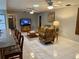 Cozy living room with comfortable seating, ceiling fans, and a large television at 3652 Oak Grove Dr, Sarasota, FL 34243