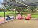 Screened patio with seating, perfect for enjoying the outdoors in comfort and style at 3652 Oak Grove Dr, Sarasota, FL 34243