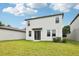 Two-story home with a well-maintained lawn, sliding glass door, and modern exterior design at 2320 E Newsome Rd, Plant City, FL 33565