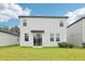 Two-story home with a well-maintained lawn, sliding glass door, and modern exterior design at 2320 E Newsome Rd, Plant City, FL 33565