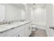 Modern bathroom featuring granite counters, double sinks, white cabinets, and a shower-tub combo at 2320 E Newsome Rd, Plant City, FL 33565