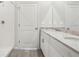 Full bathroom featuring double sinks, granite countertop, walk-in shower with tile surround and wood-look tile flooring at 2320 E Newsome Rd, Plant City, FL 33565