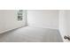Bright bedroom with a window offering natural light and a neutral carpet at 2320 E Newsome Rd, Plant City, FL 33565