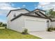 Contemporary two-story home with an attached two car garage and landscaped yard at 2320 E Newsome Rd, Plant City, FL 33565