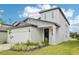 New two-story home with a well-manicured lawn, attached garage, and a welcoming front entrance at 2320 E Newsome Rd, Plant City, FL 33565