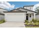 Charming two-story home featuring an attached garage and professionally landscaped front yard at 2320 E Newsome Rd, Plant City, FL 33565