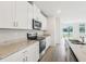 Bright kitchen with stainless steel appliances and a view of the yard and lake at 2320 E Newsome Rd, Plant City, FL 33565