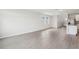Open concept living room with light wood-look flooring connecting to kitchen at 2320 E Newsome Rd, Plant City, FL 33565