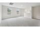 Spacious living room featuring neutral paint, carpet flooring, and large windows providing natural light at 2320 E Newsome Rd, Plant City, FL 33565