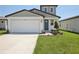 Charming two-story home with a well-manicured lawn and attached two car garage at 3826 Radiant Mountain Dr, Plant City, FL 33565