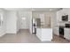 Open-concept kitchen and living area with stainless appliances and an island at 3826 Radiant Mountain Dr, Plant City, FL 33565