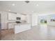 Spacious living room featuring an open concept kitchen, tile floors, and sliding glass doors at 3826 Radiant Mountain Dr, Plant City, FL 33565