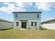 The home features a simple backyard with healthy grass and a view of the back exterior at 3904 Radiant Mountain Dr, Plant City, FL 33565
