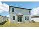 The home features a simple backyard with healthy grass and a view of the back exterior at 3904 Radiant Mountain Dr, Plant City, FL 33565