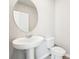 Bathroom with pedestal sink, toilet and an oval mirror at 3904 Radiant Mountain Dr, Plant City, FL 33565