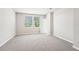 Comfortable bedroom featuring carpet flooring, neutral walls, and a door at 3904 Radiant Mountain Dr, Plant City, FL 33565