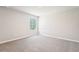 This bedroom features neutral walls, plush carpeting, and a bright window, ready for personalization at 3904 Radiant Mountain Dr, Plant City, FL 33565